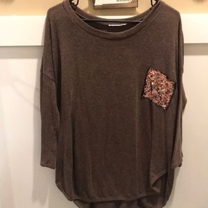 Brown tunic with sequin pocket.